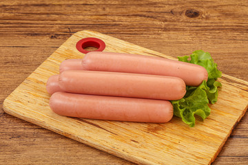 Tasty meat sausages over board