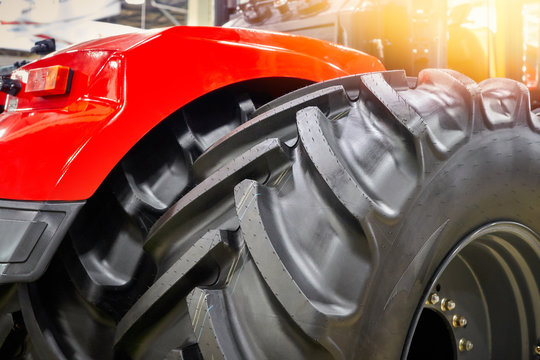 Closeup of big black rubber wheels of an agricultural tractor