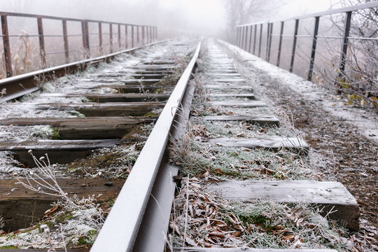 Rails in hoarfrost. Misty autumn morning.