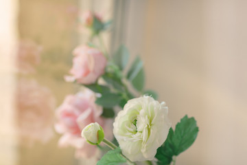 Artificial roses on the windowsill. artificial flower on the windowsill.