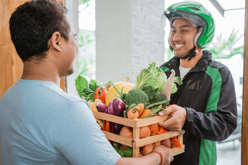 order online food courier delivering to customer at home. motorcycle delivery boy wear uniform and...