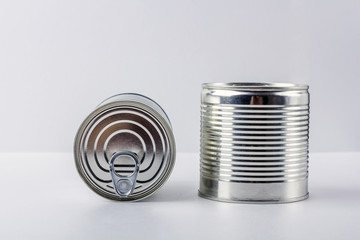 Two tin can (canned food) on white  background. Food supplies during coronavirus quarantine and self-isolation. Food delivery, donation, volunteer support. Copy space for text