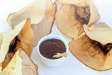 Recycling waste from coffee. Body scrub of ground coffee, homemade cosmetic for peeling and spa care and filter packs on white background. Zero waste, eco friendly, reasonable consumption concept
