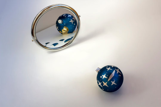 The Solid Blue Christmas Ball Is Reflected In The Mirror As Broken. Metaphor Or Symbol Of Shattered Hopes, Loss, Disappointment