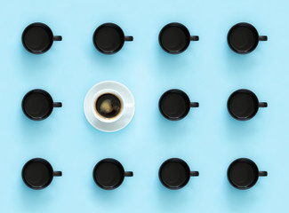 The concept is different. A lot of black mugs with tea and 1 white cup with coffee on a plain blue background