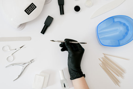Tools for manicure hand in black glove