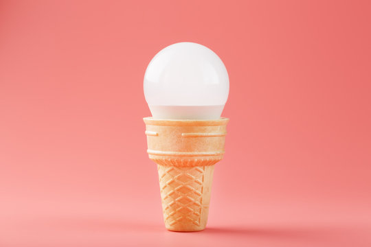 Light bulb ice cream in a waffle Cup on a pink background.
