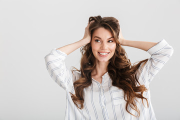 Image of joyful caucasian woman smiling and grabbing her head