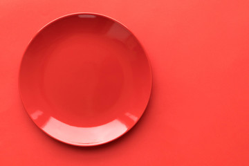 Red plate on a red background, the basis for design