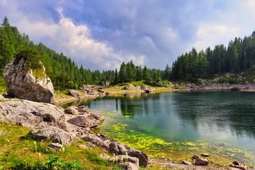 Double lake in Triglav Lakes Valley. Beautiful lake next to the Hut by the Triglav Lakes in Slovenia. Rock standing next to lake.