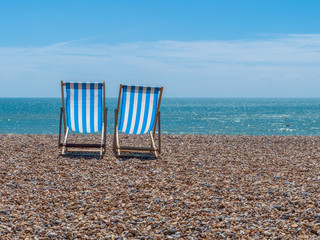 Two Deck Chairs on a Beach