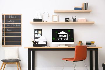 Modern computer with text HOME OFFICE on wooden table indoors