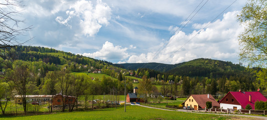 Fototapeta premium Krasna village with hills of Moravskoslezske Beskydy mountains around in Czech republic