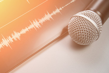 Podcast record. Microphone and sound track at tablet. Grey monochrome. Audiobook and podcasting....