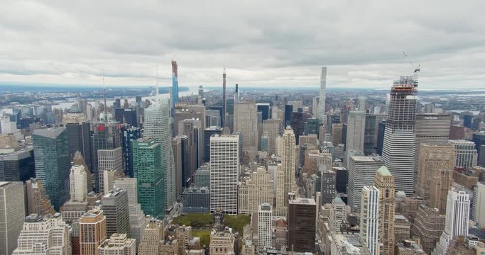 Horizontal panning shot of Bryant Park among a multitude of Manhattan skyscrapers, typical for New York City, filmed from Vantage point.