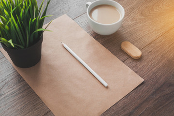 flatlay minimalism cup of coffee, sheet of paper, pencil on a wooden desktop 