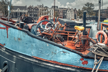 Fototapeta na wymiar Dutch blue ship in Amsterdam with a rusty bicycle on it close view
