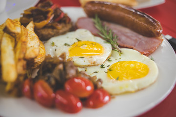 Close up image of a gourmet bacon and egg breakfast being served in a diner