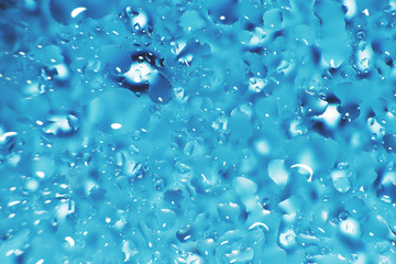 water drops on a blue background. Abstract blue background. Water drops on glass.