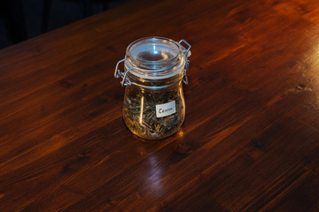 glass jar of tea on a wooden table