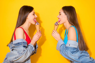Profile side photo of positive cheerful girls enjoy summer weekend free time lick delicious...