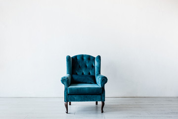 comfortable armchair near white wall in living room