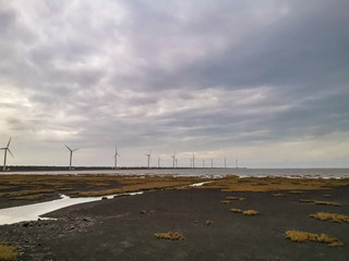 Gaomei wetland a tourist attraction with wind powered electicity generator in the background