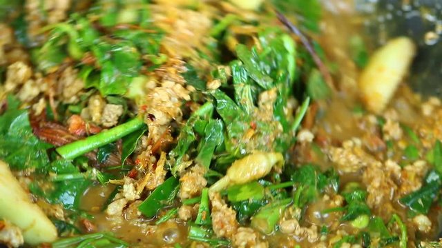 Man cooking vegetables mixed curry or Kang Care, Thai famous northern food