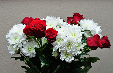 A bouquet of fresh red roses and white dahlias