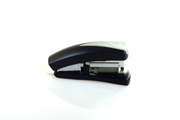 Black colored stapler on white background.