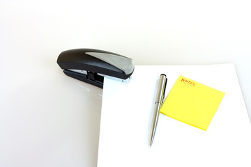 Black colored stapler with yellow note papers