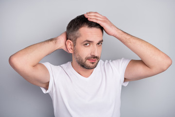 Close-up portrait of his he nice attractive well-groomed content brunet guy touching caressing hairstyle isolated over light grey pastel color background