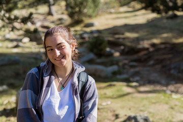 Portrait of young girl smiling with the forest in the background