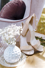 Fototapeta na wymiar beige designer women's shoes stand. Wedding details