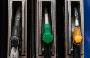 Close up petrol pump filling nozzles at the gas station. Benzine, diesel.