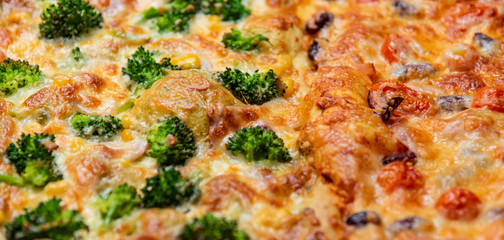 Obraz na płótnie Canvas Close up fresh pizza with broccoli, beans, cheese, cherry tomatoes.
