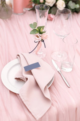 Luxurious wedding table decoration for reception of guests with stylish napkins, cute natural flower