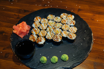 Japanese sushi rolls, large set with sesame wasabi, ginger and soy sauce on a tray