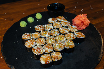 Japanese sushi rolls, large set with sesame wasabi, ginger and soy sauce on a tray