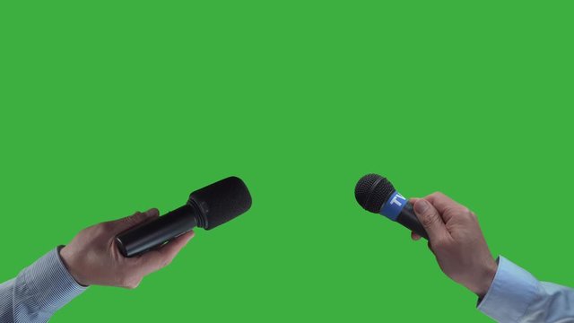 Two reporter holding mic, waiting for interview,green screen background