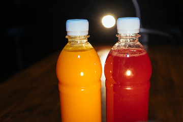 plastic bottles with soft drinks, mors and orange juice. red and yellow © kapralov