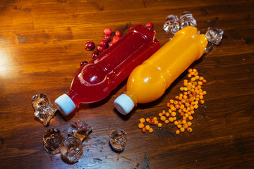 plastic bottles with soft drinks, mors and orange juice. red and yellow © kapralov