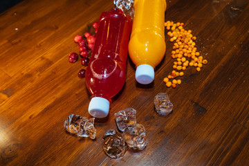 plastic bottles with soft drinks, mors and orange juice. red and yellow © kapralov
