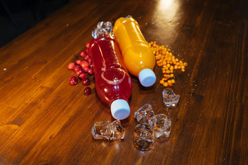 plastic bottles with soft drinks, mors and orange juice. red and yellow © kapralov