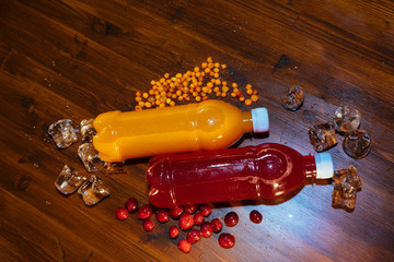 plastic bottles with soft drinks, mors and orange juice. red and yellow © kapralov