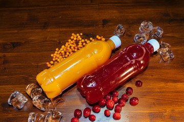 plastic bottles with soft drinks, mors and orange juice. red and yellow © kapralov