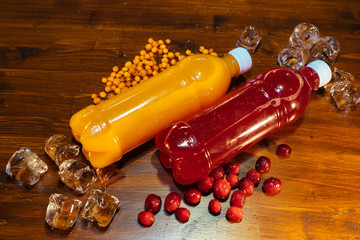 plastic bottles with soft drinks, mors and orange juice. red and yellow © kapralov