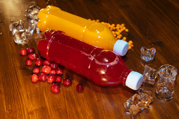 plastic bottles with soft drinks, mors and orange juice. red and yellow © kapralov