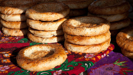 Close-up of fresh bread with poppy seeds from tandoor. Food market in Central Asia. Tasty food.