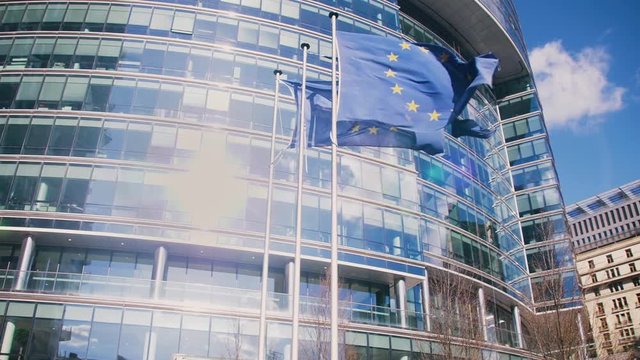 European Union building with waving European EU Flags